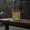 Ghost BCAA supplement container with pineapple flavour on a gym background