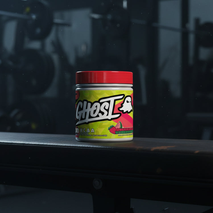 Ghost BCAA supplement container with colourful label on a gym background