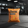 Orange package of 'The Curators Protein Chips' on a gym floor.