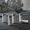 Red Bull energy drink cans on a gym floor with exercise equipment in the background