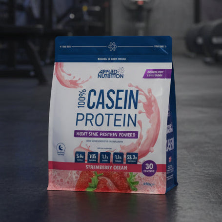 Package of Applied Nutrition 100% Casein Protein in Strawberry Cream flavour on a gym background