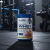 Applied Nutrition Critical Whey Tub on a gym floor