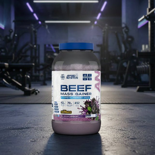 Beef mass gainer supplement container with Applied Nutrition branding on a gym background