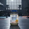 Beef mass gainer supplement container with Applied Nutrition branding on a gym background